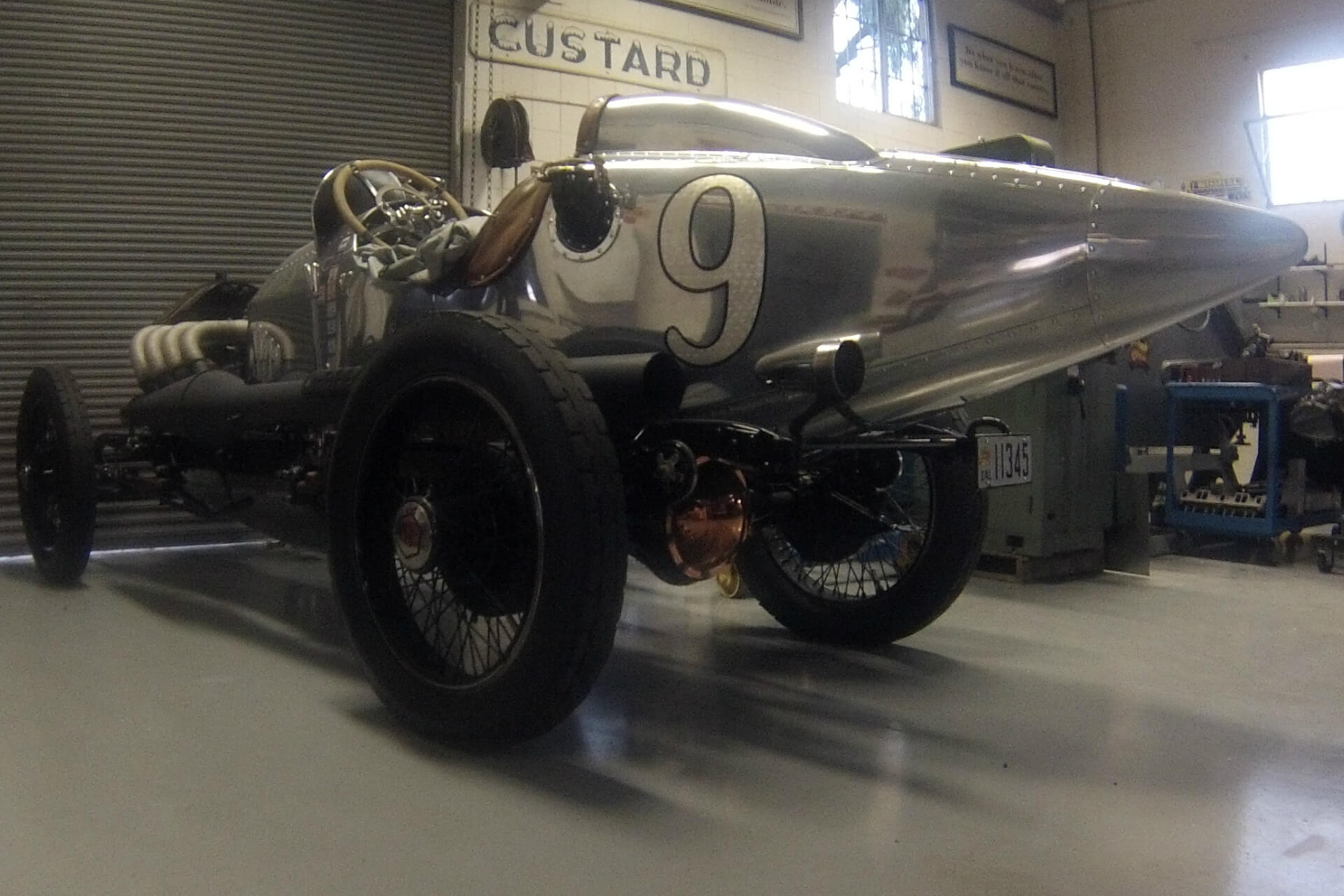 Raw aluminum vintage race car inside the Pumphrey and Co. workshop